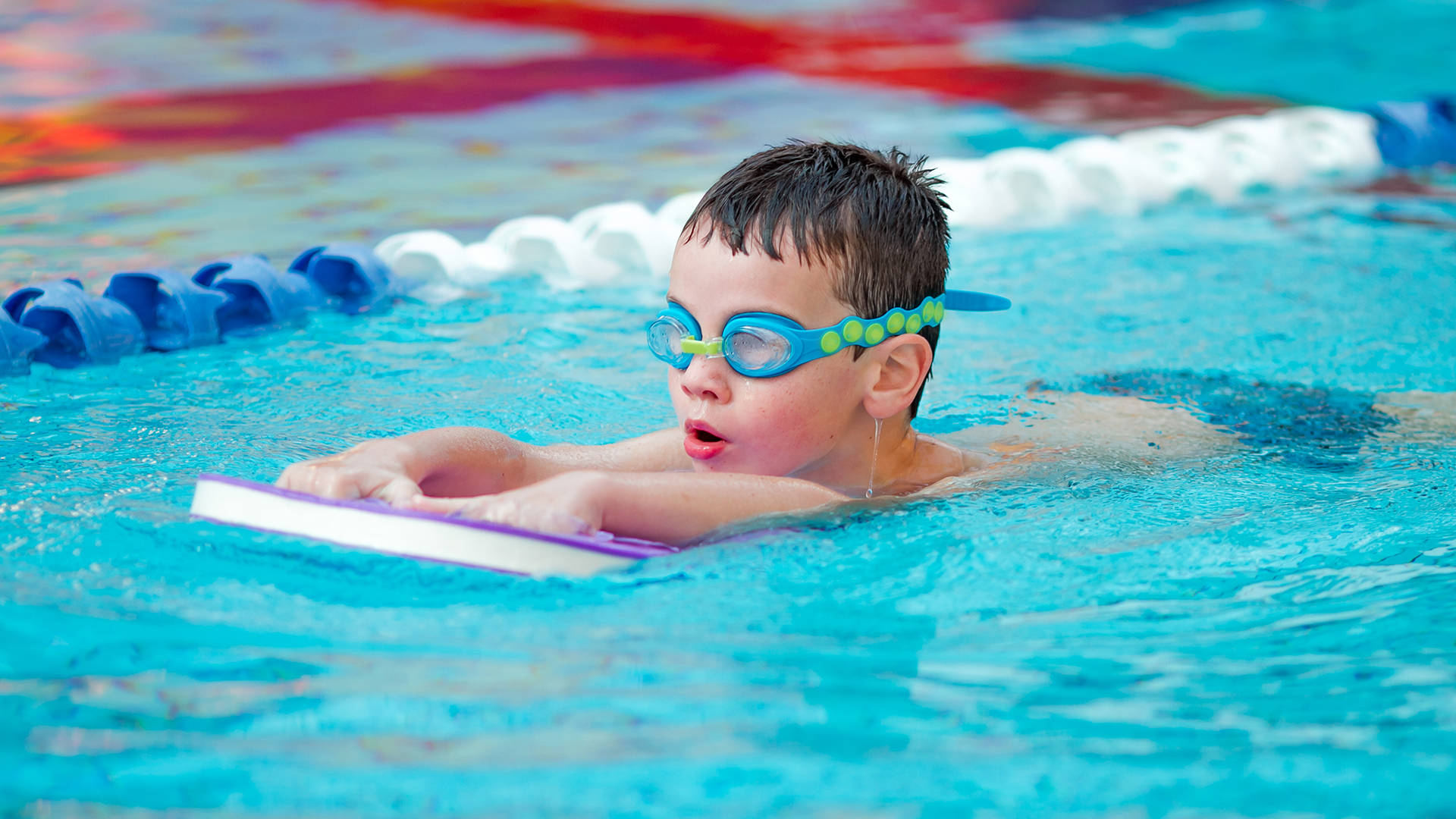 A child learning to swim during a swimming lesson in The Essex's swimming pool